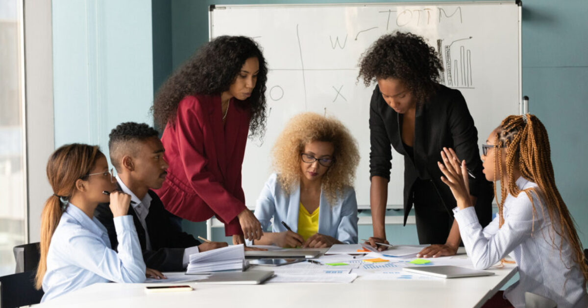 African American business team working with financial documents, brainstorming