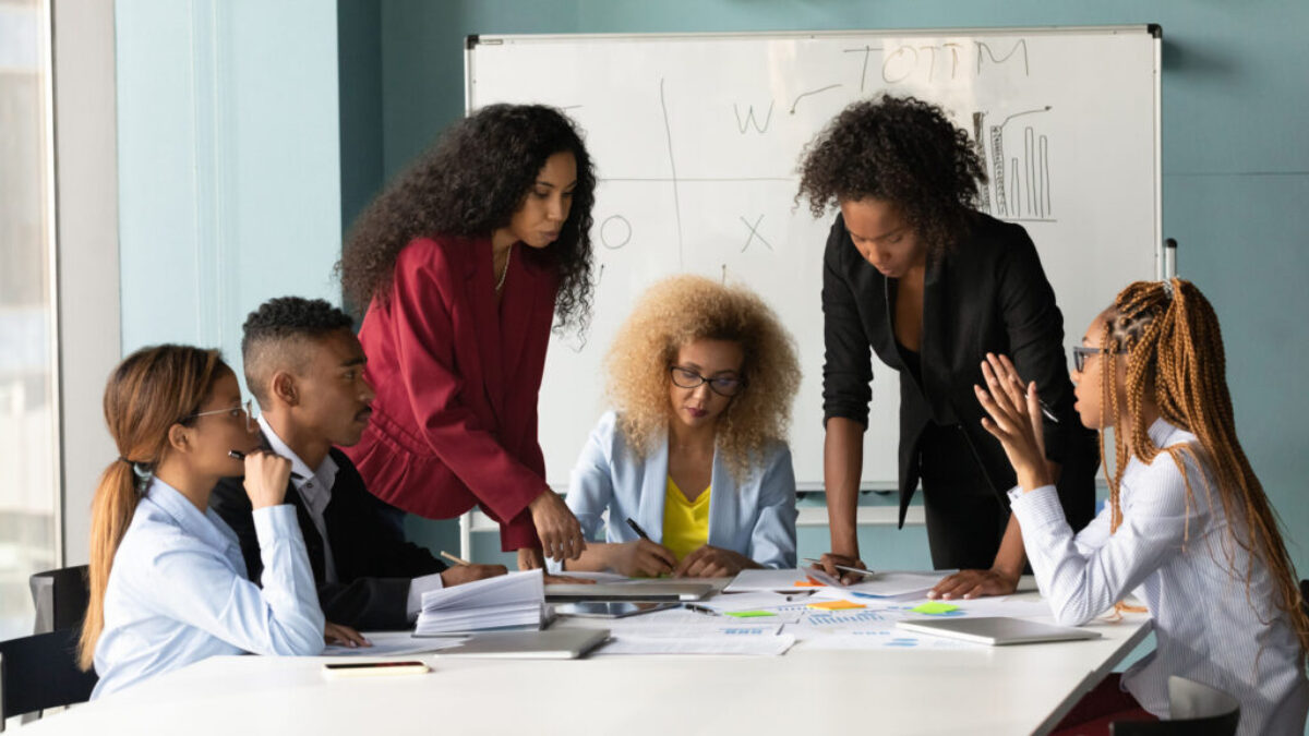African American business team working with financial documents, brainstorming